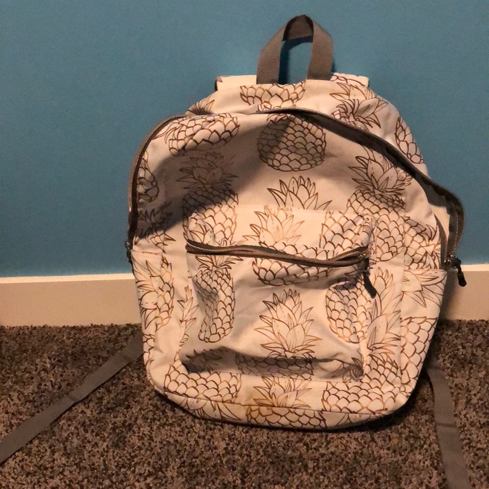 1 pineapple backpack colours gold and white with a grey interior